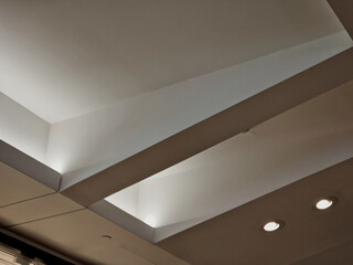 ceiling of the corridor in the plasterboard soffit is equipped with light halogens illuminating the ramp on the stage or in the shop. the goods look better if there are strong lamps in the ceiling