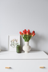 spring home decoration with flowers, bouquet of red tulips with handmade aquarelle poster on white background