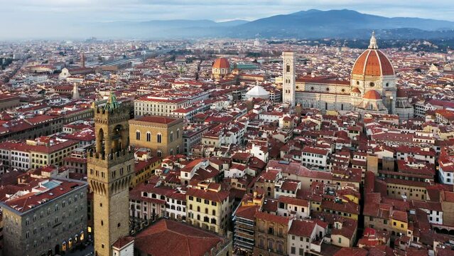 Aerial view of old town with Palazzo Vecchio tower and cathedral at sunset, Florence, Italy