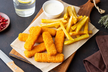 Fish fingers with french fries and white sauce. Sea food. Fish and chips.