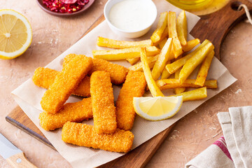 Fish fingers with french fries and white sauce. Sea food. Fish and chips.