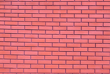 The background is a red brick wall