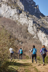 Fototapeta na wymiar Three female backpacker hikers on a pathway. Mountain trekking