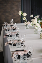 Plate and glass, stack, wineglass, luxury rich decor. Wedding set up, dinner table reception on terrace. Serving, setting table in the backyard. Birthday, baptism, event. Closeup details of interior.