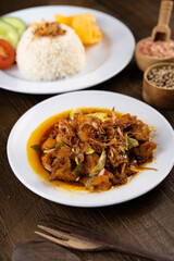 Chicken Tongseng or Tongseng ayam is an Indonesian meat or mutton stew dish in curry like soup with coconut milk, chili and sweet soy sauce. 
