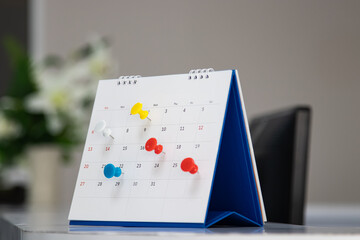 Mark on calendar white paper desk calendar with drawing-pins appointment and business meeting concept
