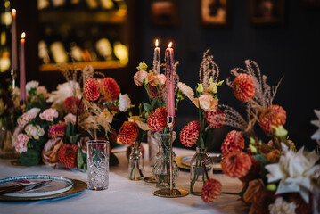 Wedding set up, reception closeup. Festive dinner table decorated with flower and greenery,...