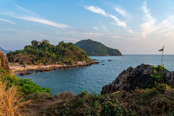 Fototapeta na wymiar Beautiful view of evening sunset at the Noen Nangphaya view point looking out to the ocean and distant islands in Chonburi, Thailand