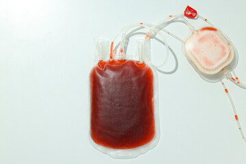 Bag with donated blood on white background, top view