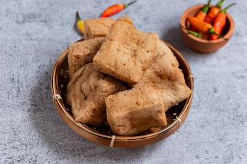 Sumedang tofu is typical tofu of the Sumedang area, also known as PONG tofu, with a textured gray background