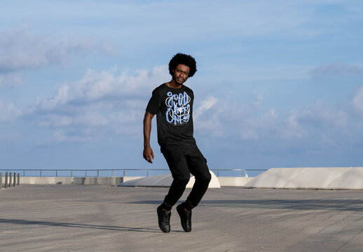 Mockup of man wearing customizable t-shirt on tiptoes