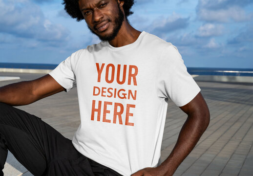 Mockup of man wearing customizable t-shirt, sitting