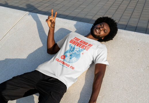 Mockup of man wearing customizable t-shirt lying down
