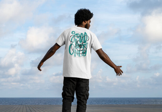 Mockup of man wearing customized t-shirt by sea