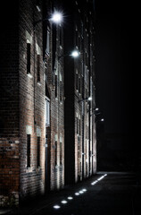 Illuminated Red-Brick Warehouses Illuminated At Night At Gloucester Docks