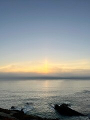 Orange sea horizon, rocky coast, evening seascape background