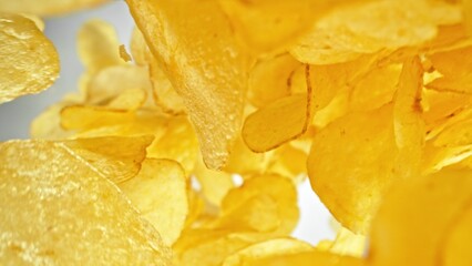 Flying Fried Potato Chips Levitating in the Air. Concept of Flying Junk Food. Selective Focus.