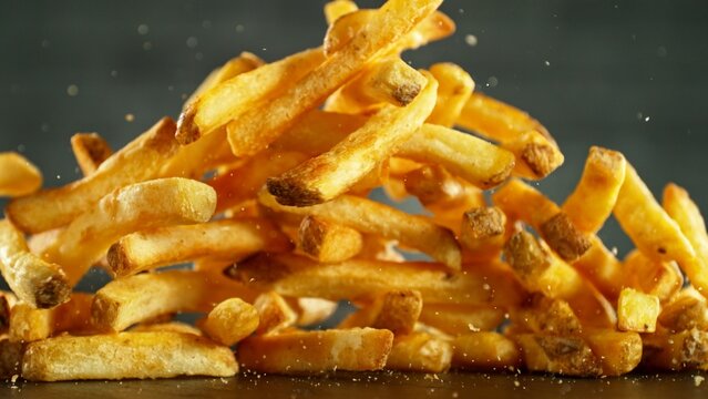 Flying French Fries Falling on Table. Fast Food Concept with Flying Food.