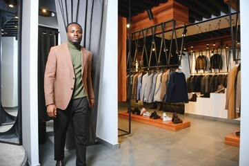 Fototapeta na wymiar African businessman in elegant classic suit in a premium men's clothing store