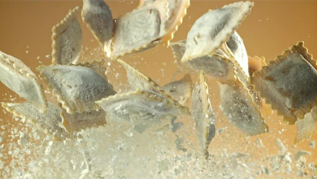 Italian ravioli fly up and fall down with flour. Filmed on a high-speed camera at 1000 fps. High quality FullHD footage