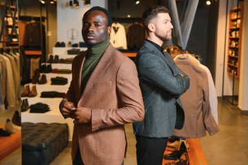 Two handsome respectable men in elegant classic suits in a premium men's clothing store