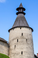 Fototapeta na wymiar Stone tower and wall of the Kremlin of Pskov, Russia. Ancient fortress