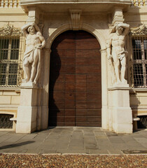 Ancient entrance with statues of a palace in Mantua, Lombardy, Italy