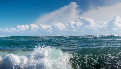 Powerful foamy sea waves rolling and splashing over water surface against cloudy blue sky, panoramic image with copy space