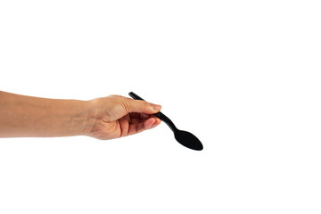 Black plastic spoon in hand on transparent background