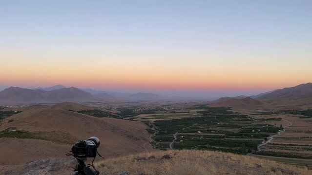 Photography experience in mountain highland panoramic landscape view of wide horizon blue sky line in mountain region in Esfahan the garden orchard field green hay bale fruit tree a colorful twilight