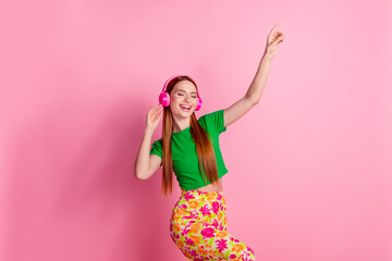 Portrait of adorable girl with redhead hair wear stylish top touching headphones listen pop music...