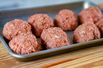 Beef cutlets preparation for roasted. Homemade meat patties on plate, close up, selective focus