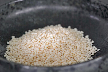 Mochi rice in bowl preparation for cooking, close up, selective focus