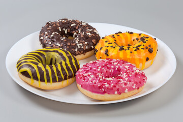 Doughnuts with different filling, glazes and sprinkles, side view