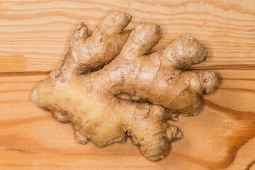 Fresh ginger root on a wooden surface, top view