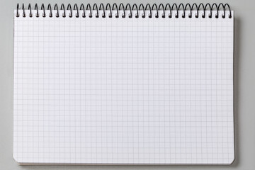 Blank squared sheet of exercise book with wire spiral binding