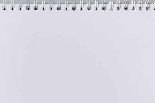 Blank white sheet of exercise book with wire spiral binding