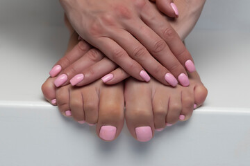The picture of female legs and hands after pedicure and manicure