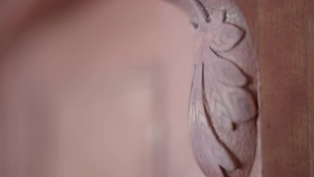Close up on the intricate carvings of wooden furniture highlighting the artistic craftsmanship