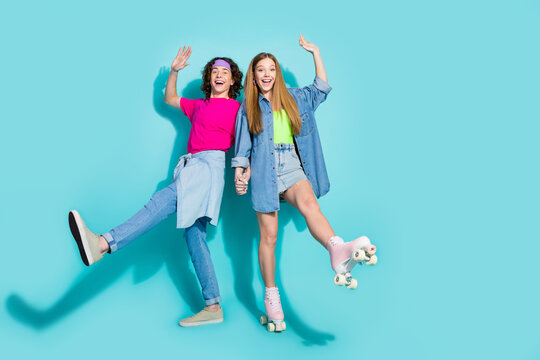 Full body photo of shopping day teenagers pair dancing holding arms together hands up wear roller skates isolated on can color background