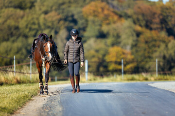 Girl rider goes riding with her horse ready to ride.