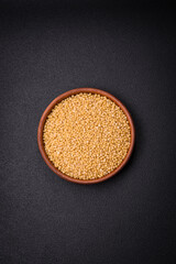Ptitim wheat porridge grains on a dark concrete background