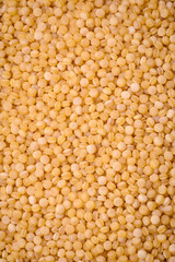 Ptitim wheat porridge grains on a dark concrete background