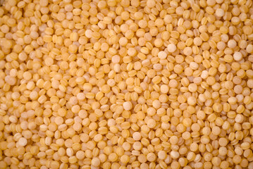 Ptitim wheat porridge grains on a dark concrete background