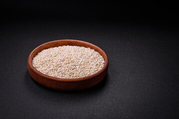 Large grains of uncooked white rice in a ceramic bowl