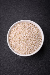 Large grains of uncooked white rice in a ceramic bowl