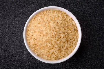 Large grains of uncooked white rice in a ceramic bowl
