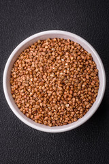 Large grains of raw buckwheat porridge are brown in color