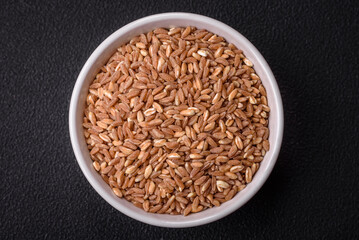 Large grains of wheat porridge are brown in color when raw
