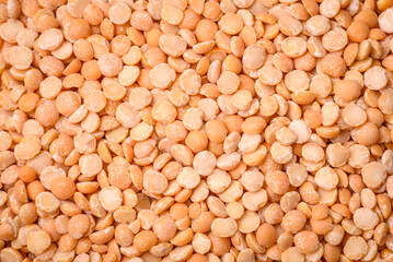 Dried pea grains, divided into halves, are yellow in color when raw
